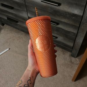 Orange studded Starbucks Cup
